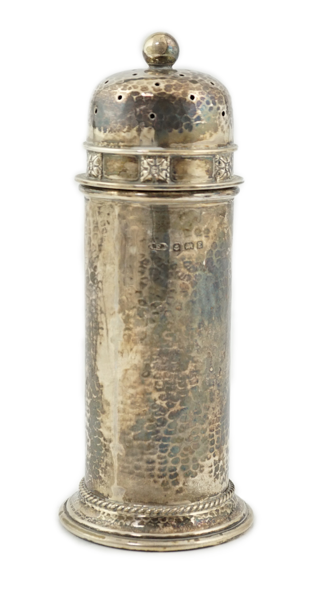 A George V Arts & Crafts planished silver sugar castor by Albert Edward Jones, of lighthouse form, Birmingham, 1929, 16.7cm, 5.3oz. Condition - fair to good